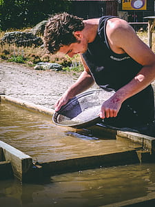 man washing gray steel wok thumbnail