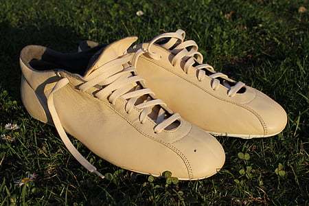pair of brown leather shoes on green grass thumbnail