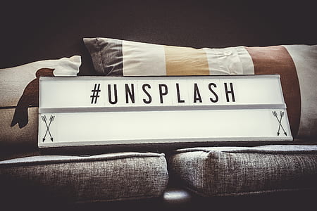 white and gray Unsplash decor on gray cushions thumbnail