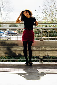 woman standing in front of gray metal fence thumbnail