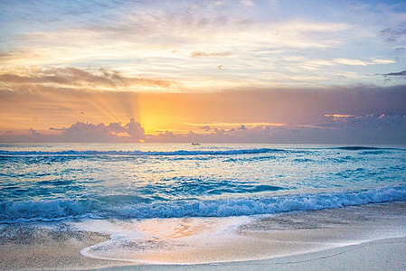 body of water and white sand photo taken during daytime thumbnail