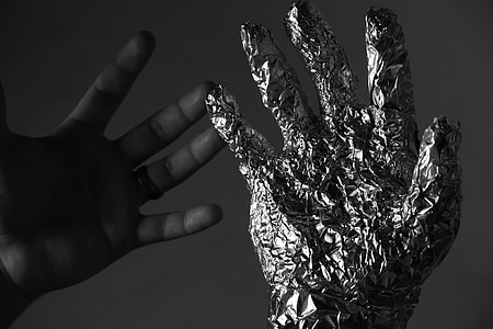 grayscale photography of person's right hand covered in aluminum foil thumbnail