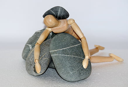 human action figure on gray stone fragment thumbnail