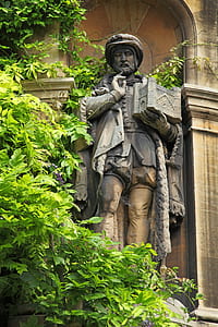 man holding book statue thumbnail