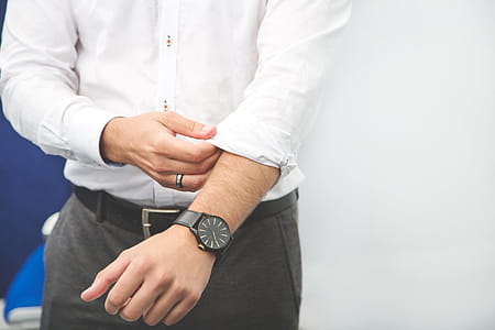 Businessman Rolls Up Sleeve Photo thumbnail