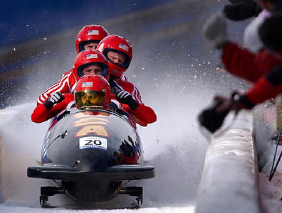 four man riding black vehicle on ice thumbnail