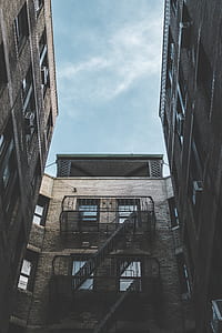 photo of white high-rise building under blue sly thumbnail