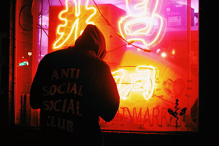 man standing in front of neon signage thumbnail
