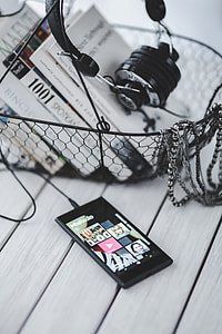 Black smartphone and headphones with various items thumbnail