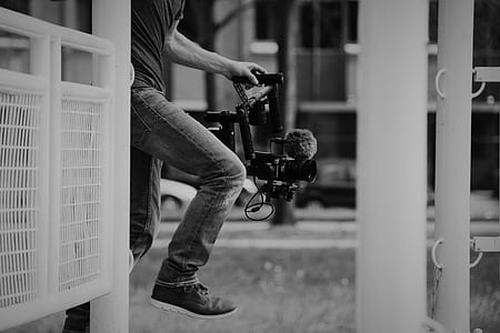 grayscale photo of a person holding camera thumbnail