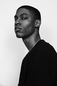 man standing in grayscale photo thumbnail