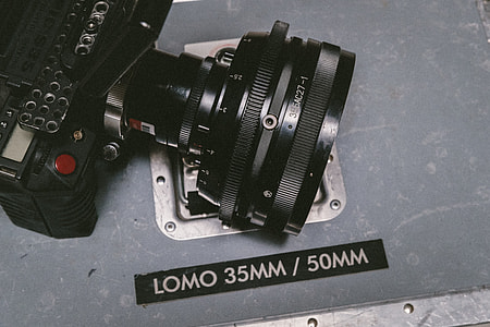 35/50 mm black Lomo 395AC27-1 camera lens placed on gray metal board thumbnail
