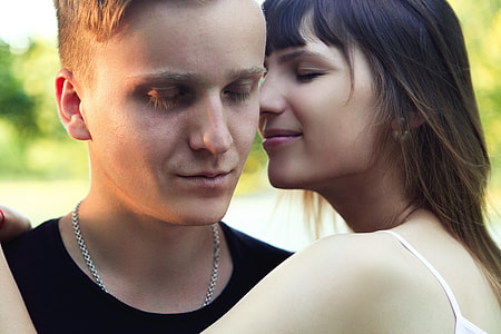 man and woman facing each other while closing eyes thumbnail