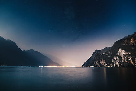 city buildings near mountains and body of water thumbnail