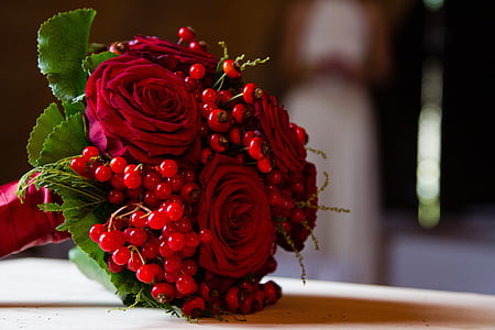 red rose bouquet on brown wooden surface thumbnail