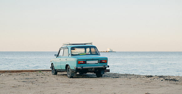 blue Tofas Serce sedan near sea at daytime thumbnail