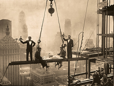 grayscale photo of man taking dinner in crane thumbnail