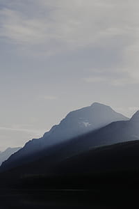 mountain under white cloudy sky at daytime thumbnail