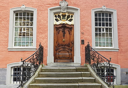 closed brown wooden door of red brick building thumbnail