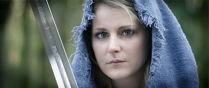 woman wearing blue hood holding gray sword thumbnail