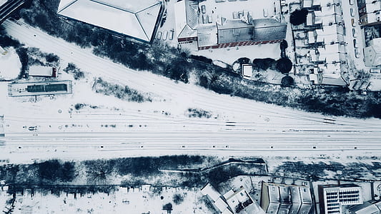 aerial photo of snow-capped road near building thumbnail