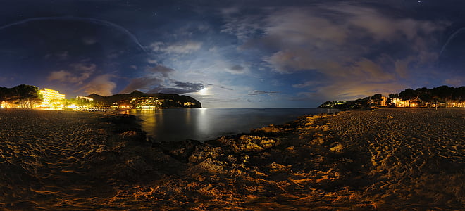 panoramic photography of lightened buildings near shoreline at nighttime thumbnail