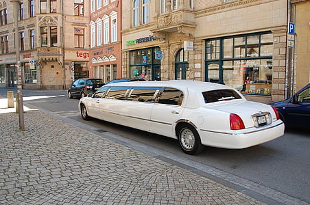 white vehicle near bron building during daytime thumbnail