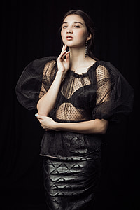 woman in black mesh illusion dress posing for photo thumbnail