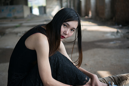 woman wearing black lace sleeveless long dress sitting thumbnail