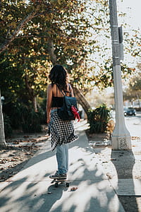 woman riding on skateboard beside the lamp post thumbnail