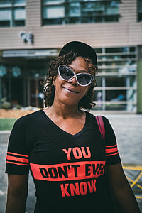 person wearing black crew-neck shirt with orange You Don't Ever Know text thumbnail