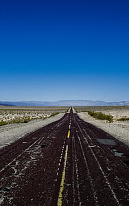 gray pave road during daytime thumbnail