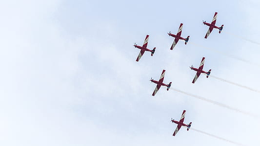 red and white jet trail at daytime thumbnail