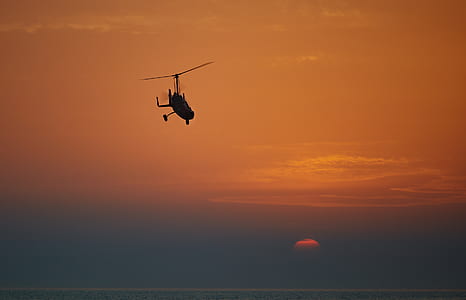 black helicopter under sunset thumbnail