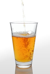 clear glass cup filled with gold liquid thumbnail