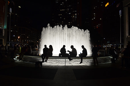 silhouette of people sitting near fountain thumbnail