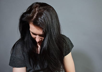 woman in gray t-shirt facing down head thumbnail