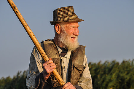 man holding brown wood stick outdoors thumbnail