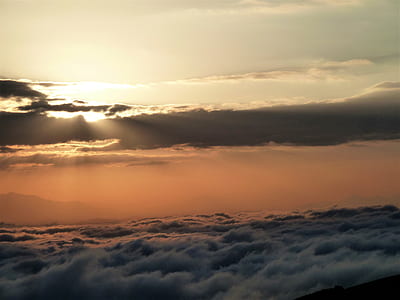 ocean waves under gray and white clouds at golden hour thumbnail