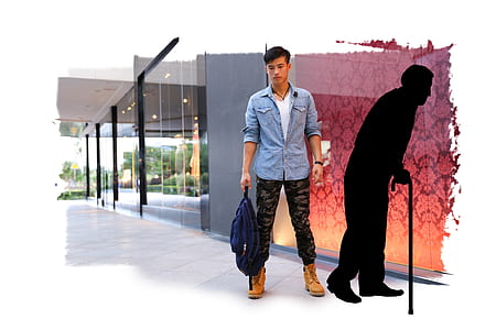man standing while holding blue backpack thumbnail