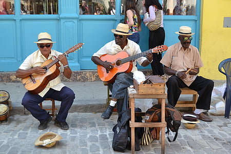 three man playing instrument on road thumbnail