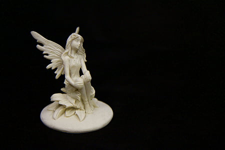 shallow focus of white ceramic angel figurine thumbnail