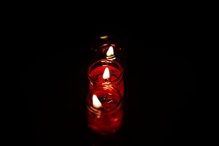 Photography Three Tealight Candles in Dark Place thumbnail