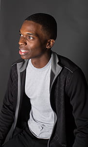 man wearing white crew-neck shirt and black zip-up jacket thumbnail