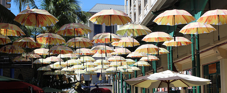 white umbrella hanging on wire thumbnail