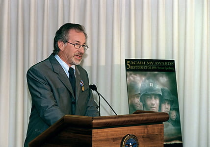man talking on lectern thumbnail