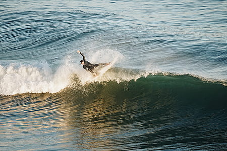 man doing surfing during daytime thumbnail