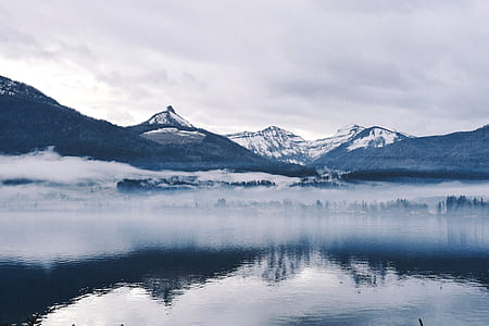 black and white mountain near body of water thumbnail