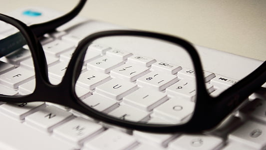 black framed eyeglasses and white comptuer keyboard thumbnail