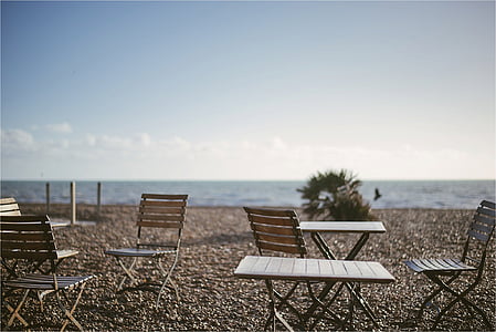 empty tables and chairs on brown soil at daytime thumbnail